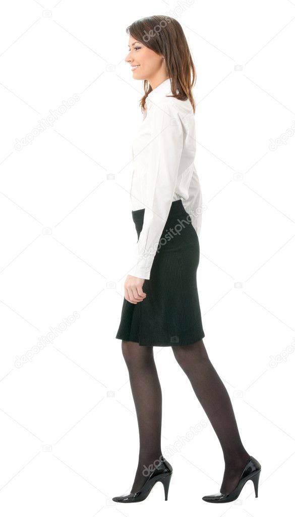 Full body of walking businesswoman, on white