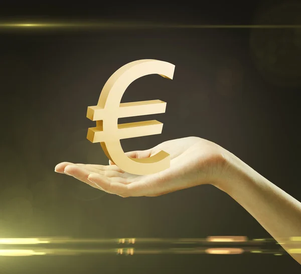 3d oro euro signo en la mano de una mujer — Foto de Stock
