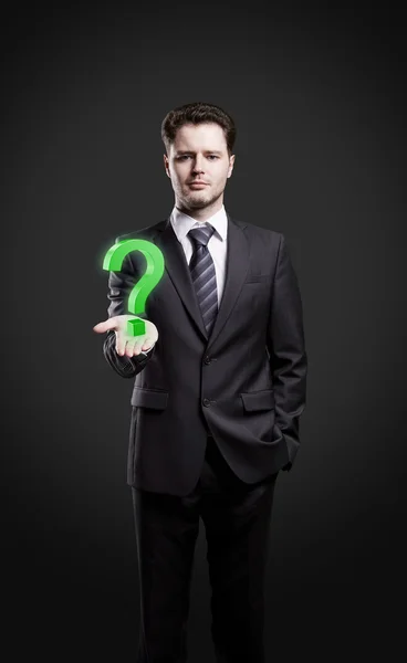 Young businessman with a question mark on his hand — Stock Photo, Image