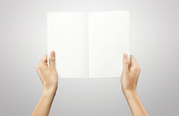 Female hands holding a blank white notebook