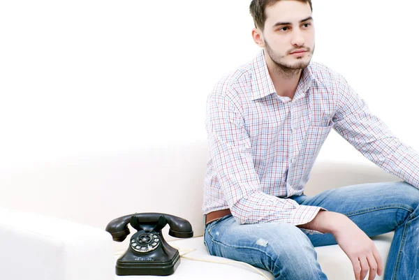 stock image Young male sitting on couch