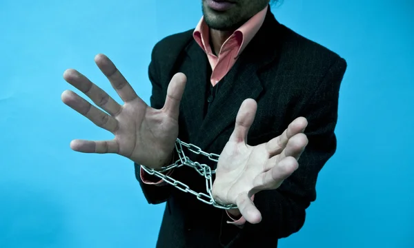 stock image Business man with hands in chains