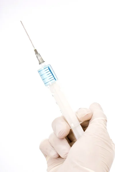 Hand holding injection on white background with blue liquid — Stock Photo, Image