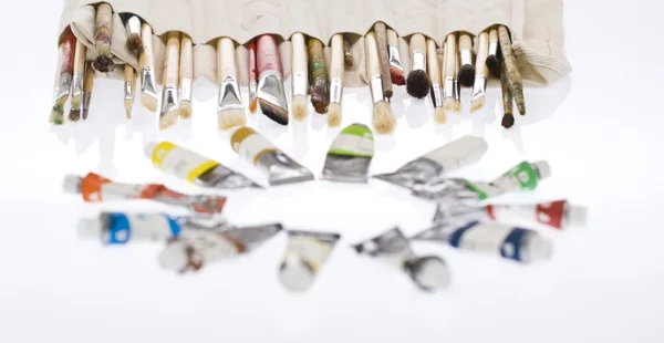 stock image Different sized brushes with tubes of color