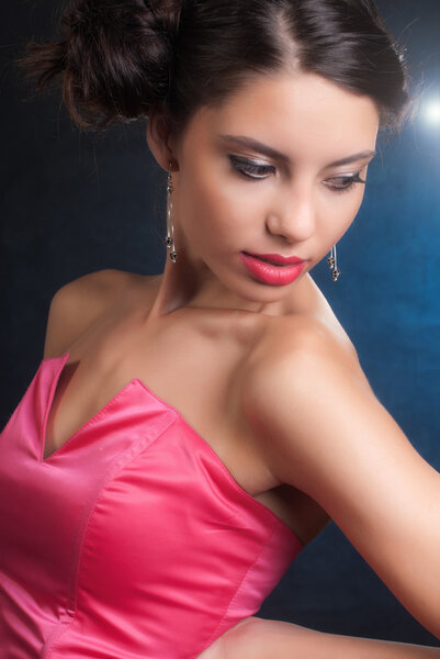 Glamour girl with red lips and red dress, isolated on black.