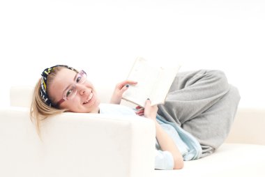 Relaxed girl, on the sofa, smiling clipart