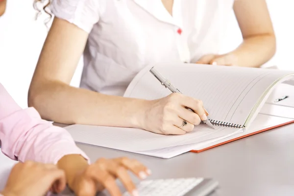 Girl sitting at desk and writing diary — Stock Photo, Image