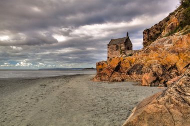 The beach near Mont Saint-Michel abbey clipart