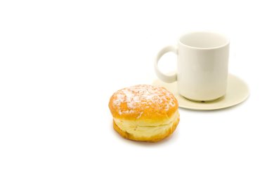 A cup of tea and a yellow donut