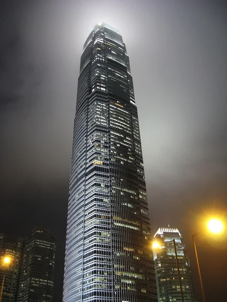 Skyscraper at night in the mist — Stock Photo, Image