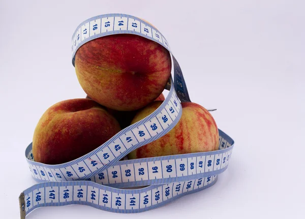 Peaches and tape measure — Stock Photo, Image