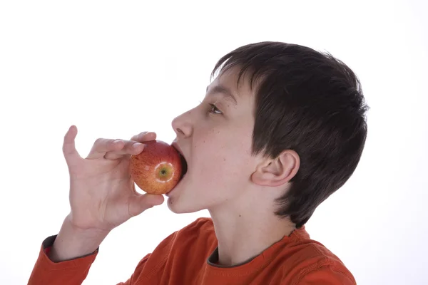 stock image Boy eating a red apple