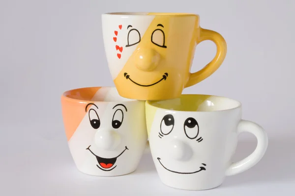 Three cups with happy expression — Stock fotografie