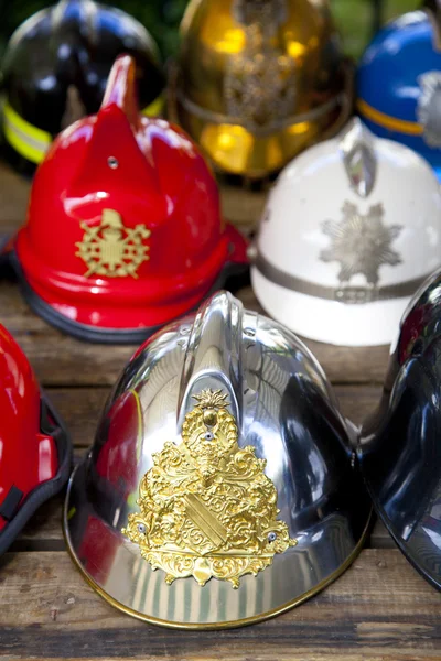 Several fireman helmets in row