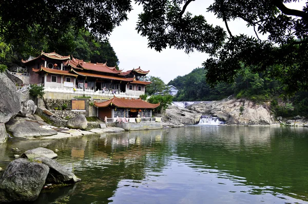 A buddhist temple overlooking river pool — Stock Photo, Image