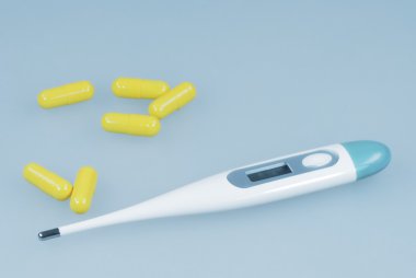 Clinical thermometer and pills against flu clipart