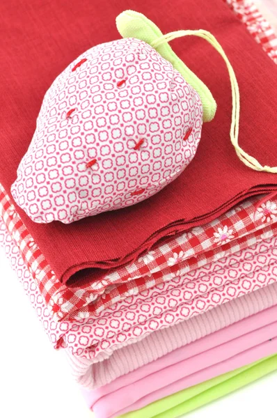 Pincushion on a Pile of Textile — Stock Photo, Image