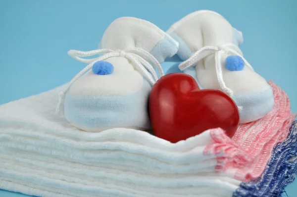Red Heart and Baby Clothes — Stock Photo, Image