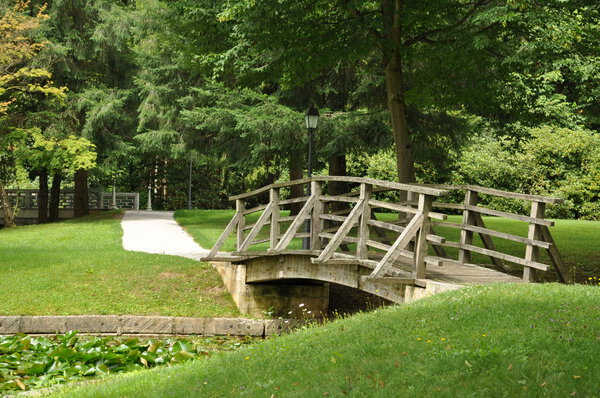 Wooden bridge in the landscaped park