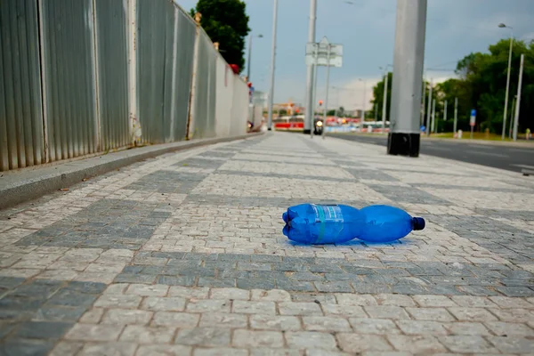 PET bottle on sidewalk