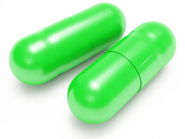 Twee glanzende groene pillen (medische capsules) — Stockfoto