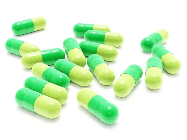 Muchas píldoras verdes en blanco — Foto de Stock