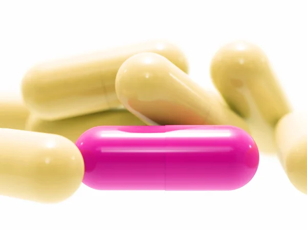 Pillole rosa e beige su bianco — Foto Stock
