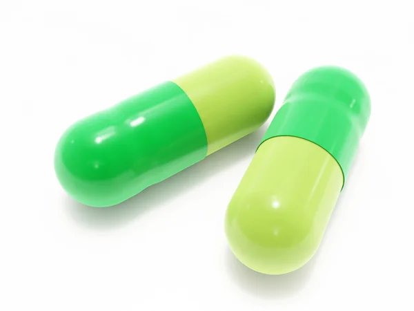 Deux pilules vertes sur blanc — Photo