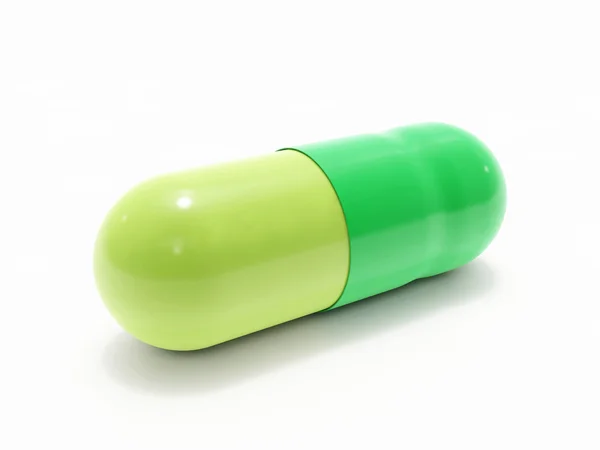 Pilule verte sur blanc — Photo
