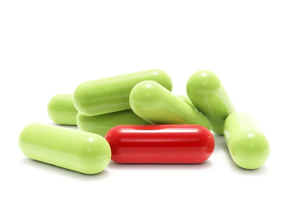 Pílulas vermelhas e verdes em branco — Fotografia de Stock