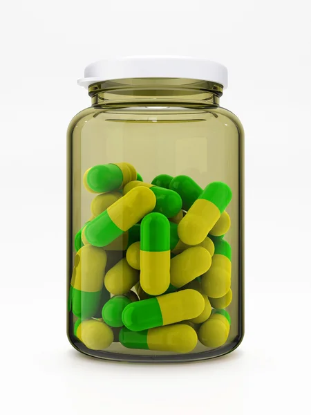 Pilules vert-jaune en flacon médical sur blanc — Photo