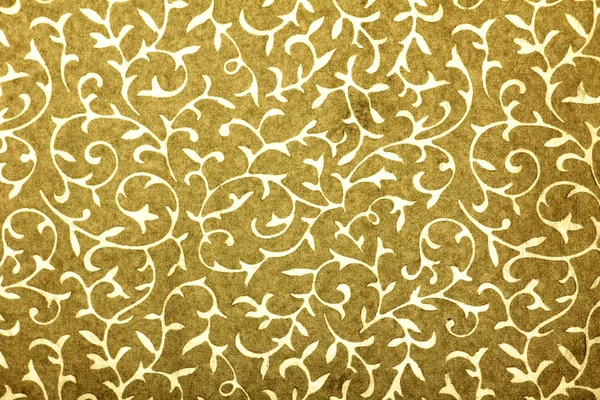 Golden handmade art paper with leaf twirl pattern — Stock Photo, Image