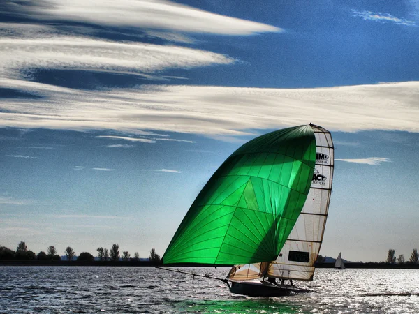 Sailing Dinghy under a cloudy sky — Stock Photo, Image