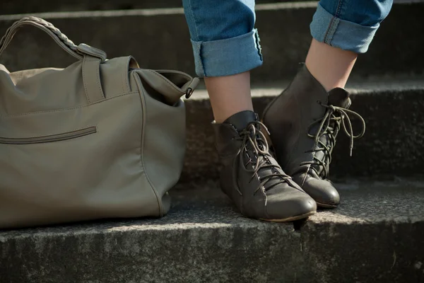 stock image Feet girl holding a bag on the stairs in jeans