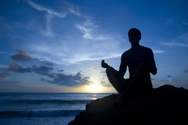 Keeping sun - young man meditating on the beach — Stock Photo, Image