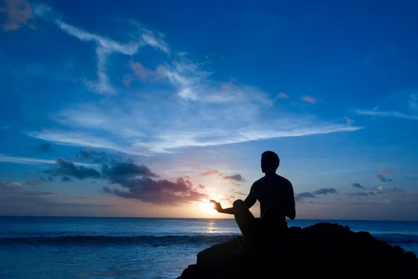Keeping sun - young man meditating on the beach — Stock Photo, Image