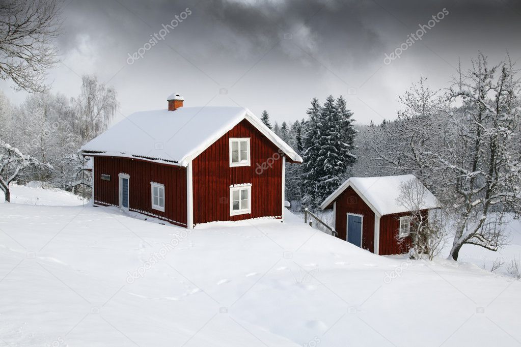 Red cottage in snowy landscape