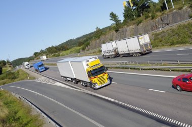 Trucks and trafic on large highway clipart