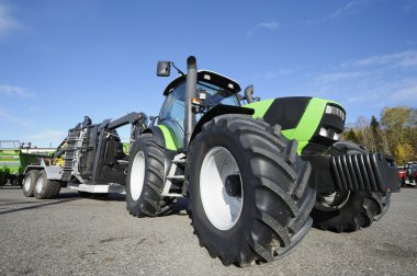 Giant farming tractor and plough clipart