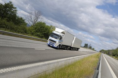 Trucking on scenic freeway clipart