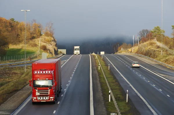 Trucks and misty mountain pass — Stock Photo, Image