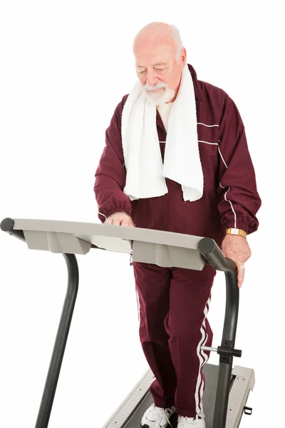 Starší muž na běžecký pás — Stock fotografie