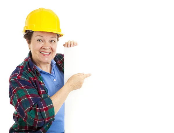 Female Worker Points at Sign — Stock Photo, Image