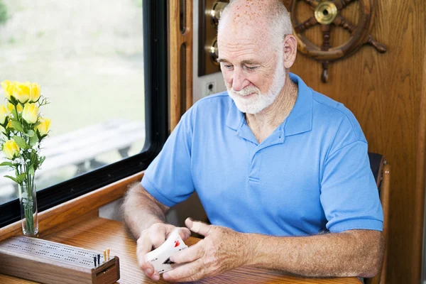 Starszy mężczyzna tasuje karty — Zdjęcie stockowe