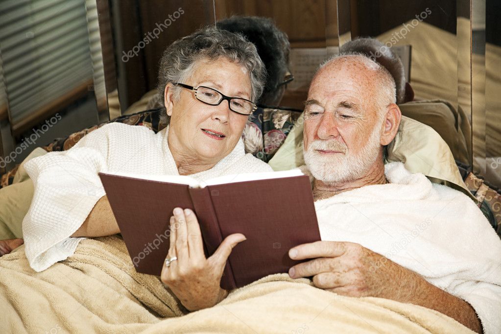 Senior Couple Reading in Bed