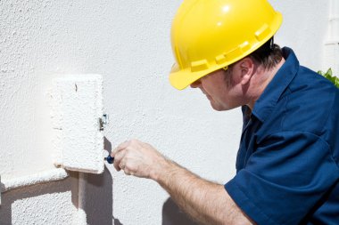 Electrician Working in Electrical Box clipart