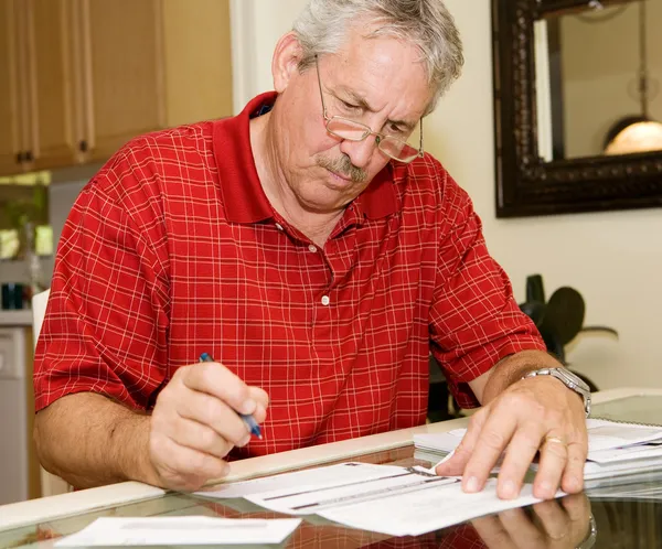 Mature Man Signing Papers — Stock Photo, Image