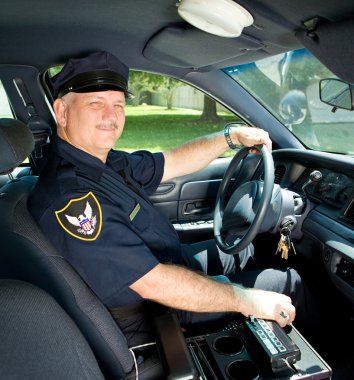 Police Officer Drives Squad Car clipart