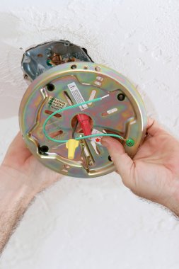 Attaching Fan Plate to Ceiling Box clipart