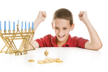 Boy Spinning the Chanukah Dreidel clipart